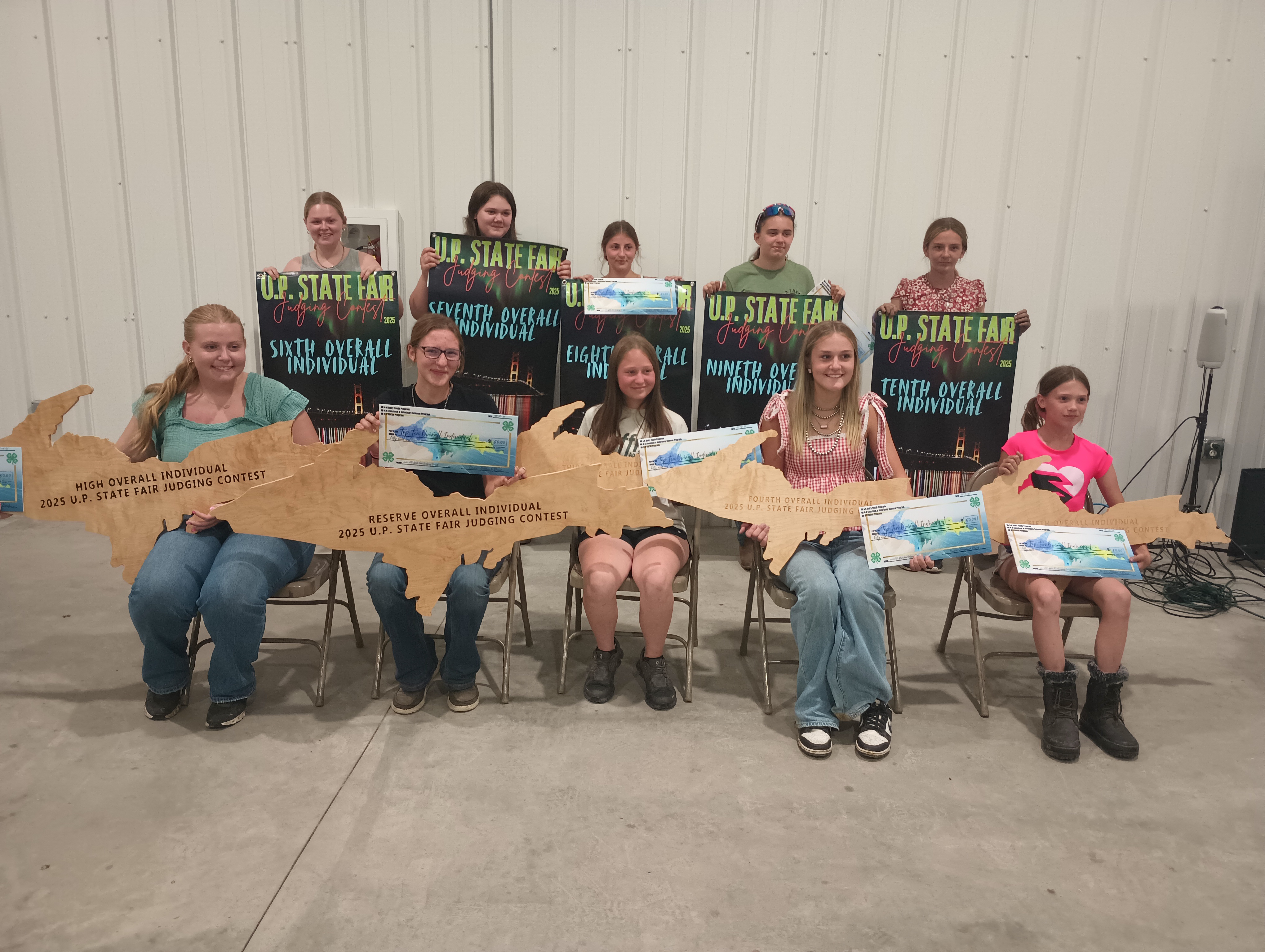 A group of youth showing off their prizes.